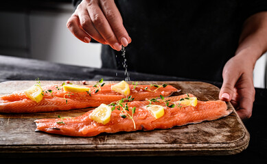 Chief Salting With A Pinch Of Salt Raw Red Trout Fish For Cooking