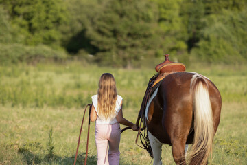 Little Girls with Horses riding western quarter horse and paint horse cowgirls in pink having fun walking away