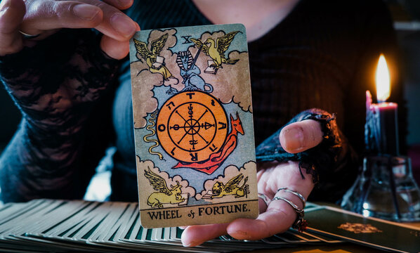 Malmö, Sweden - April 1, 2024: Wheel of Fortune Major Arcana Tarot Card Rider Waite Smith. Spiritual altar, Divination tool, witchcraft, healing crystals, fortune telling cards, cartomancy.