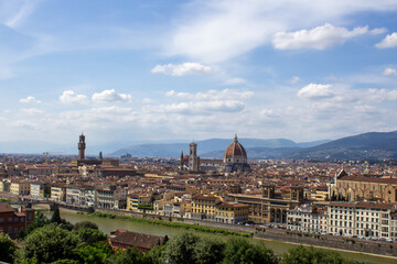 Florence's historic skyline unfolds with the iconic Duomo and Palazzo Vecchio, framed by the Arno River and lush Tuscan hills. - obrazy, fototapety, plakaty