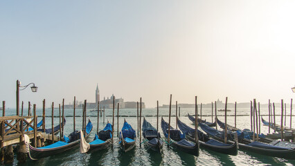 Blue gondolas on a pier at San Marco square on a sunny winter day, Venice, Veneto, Italy