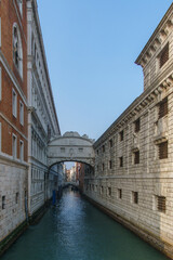 Fototapeta na wymiar Small canal passing towards famous Bridge of Sighs or Ponte dei Sospiri, Venice, Veneto, Italy