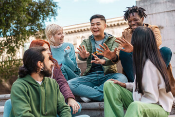 Vibrant group of multicultural students sharing a joyful moment, symbolizing the spirited camaraderie and diversity of university life - multiethnic friends interacting in the campus