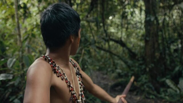 Huaoranis young Man using a Blowgun