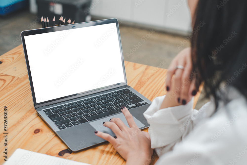 Poster close-up back view of a business woman working in the office typing, looking at the screen. office w