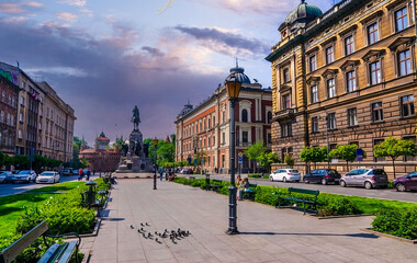 Explore the Historic Walkway beside the Monument in Krakow, Poland at Sunset.