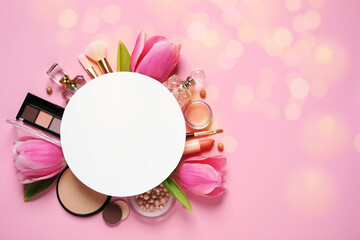 Different makeup products, beautiful tulip flowers and blank card with space for text on pink...