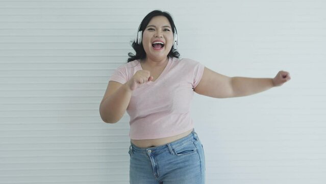fat Asian woman listening to music and dancing
