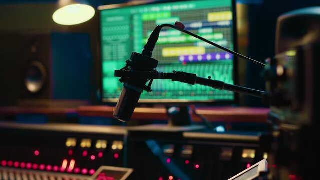 Empty professional recording studio with audio software on pc and control desk buttons or sliders. Technical equipment used to mix and master tracks, editing in post production.