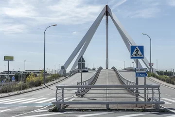 Photo sur Plexiglas Atlantic Ocean Road metal structure of a small bridge with indicative signage of road traffic vertically and horizontally on the pavement