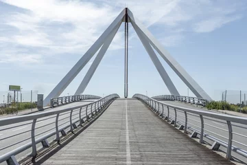 Papier Peint photo autocollant Atlantic Ocean Road Metal structure of a small bridge with hanging metal structure, walkways and wooden floors for pedestrians on a nice sunny day