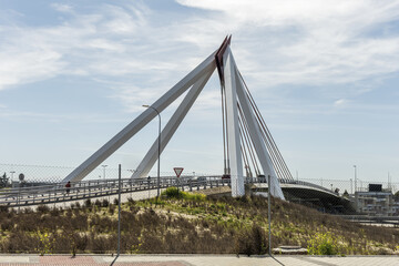 small suspension bridge with metal structure over a highway