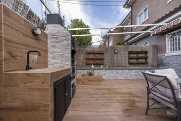 Backyard of a single-family home with imitation wood stoneware floors, outdoor dining table and...