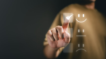 Business people are touching the virtual screen on the happy Smiley face icon to give satisfaction...