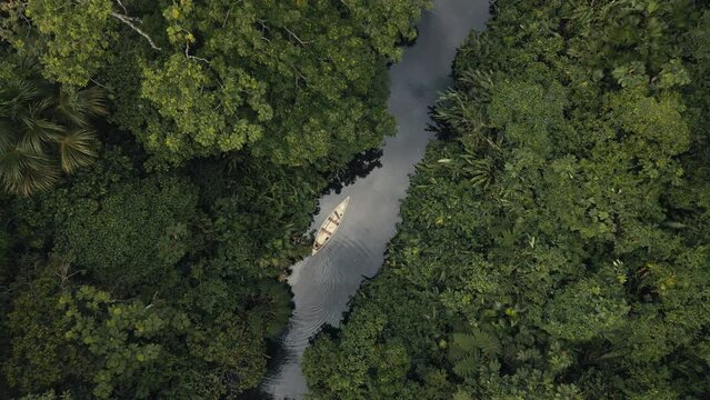 Directly above a tribe man in a canoe fishing