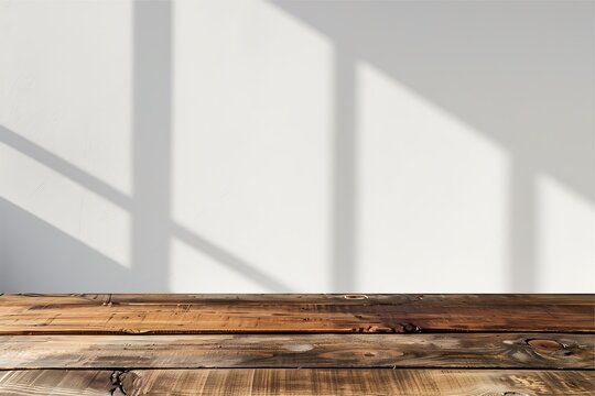 Empty wooden table on white wall and shadow background. Surface display for mockup.