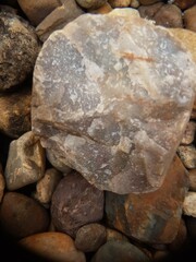 abstract Textured background with round pebble stones. Vacation holiday recreation on beach concept. High quality photo. Fragment with a texture of rock. surface  stone wall with cracks.