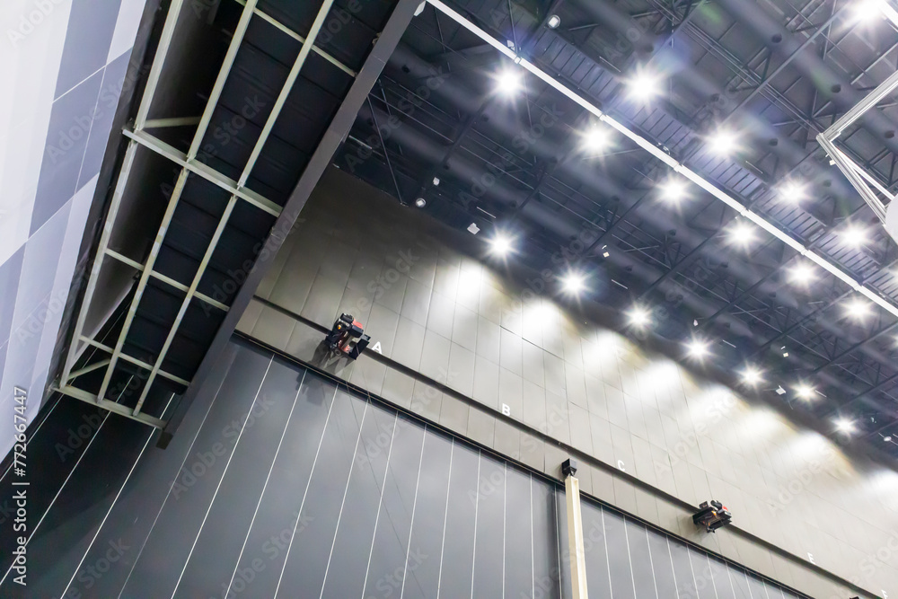 Poster a huge hall the size of a building with a steel ceiling construction. install illumination throughou
