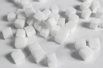 Fototapeta na wymiar Sugar cubes on a white background Sugar industry business