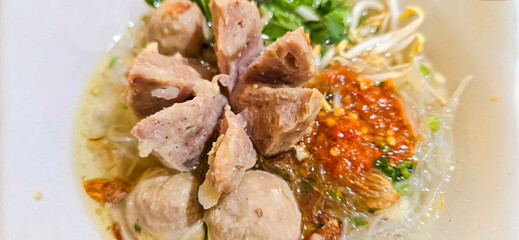 Bakso, indonesian meatball style served with beef broth soup and noodle springkled with fried onion and spring onion coupled with chili sauce on the top