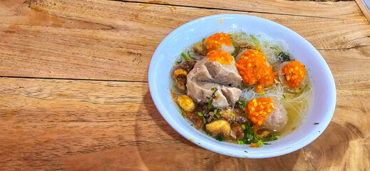 Bakso, indonesian meatball style served with beef broth soup and noodle springkled with fried onion and spring onion coupled with chili sauce on the top
