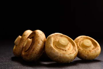Fresh organic button mushroom placed on black background. Local ingredient for healthy vegetarian...