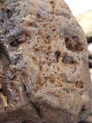 abstract Textured background with round pebble stones. Vacation holiday recreation on beach concept. High quality photo. Fragment with a texture of rock. surface  stone wall with cracks.