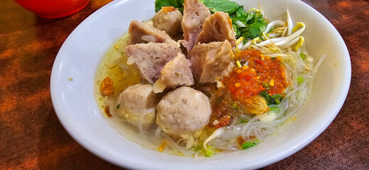 Bakso, indonesian meatball style served with beef broth soup and noodle springkled with fried onion and spring onion coupled with chili sauce on the top