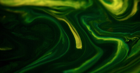 Sparkling ink spill. Liquid marble. Defocused green yellow color shiny glitter particles acrylic...