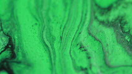 Glitter ink liquid. Oil fluid flow. Defocused neon green black color drip paint emulsion gloss...