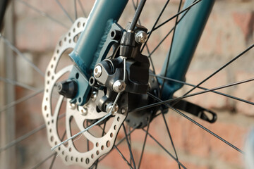 Bicycle operation and maintenance. The front hub of the wheel and the fork of the bike. The appearance of the disc brake design.