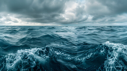 Wide-angle view of the open ocean on a cloudy day, teeming with various species of phytoplankton that contribute to the carbon cycle by photosynthesizing.