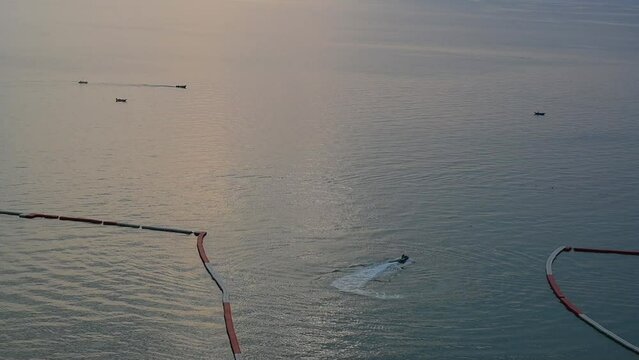 floating buoy barrier on sea, water wave in the evening