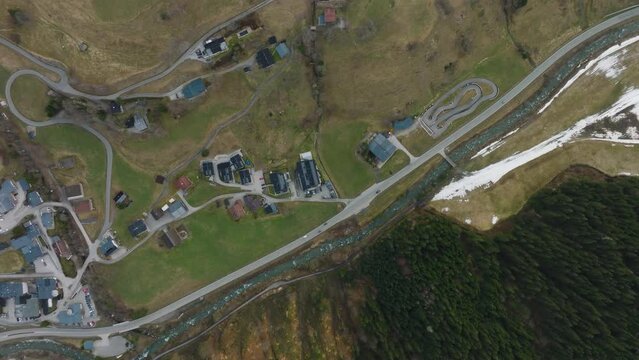 Saalbach-Hinterglemm (Austria) ski resort with winding roads and green slopes, aerial view