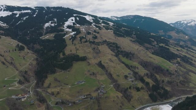Saalbach-Hinterglemm (Austria) ski resort with a tilt-down reveal during spring thaw, aerial view