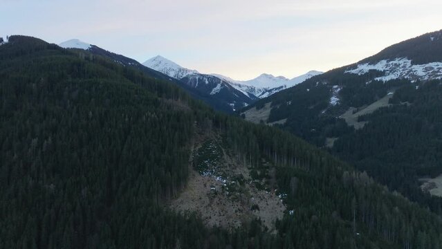 Saalbach-Hinterglemm ski resort in Austria with snow-capped mountains during dusk, aerial view