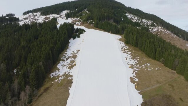 Saalbach-Hinterglemm (Austria) ski resort with melting snow in the morning, aerial view