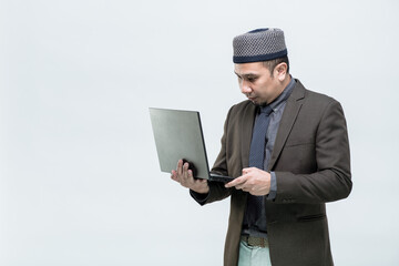 Business man, Muslim man, A muslim man office worker is watching a job at Computer Center laptop. His face with a smile, on white background.