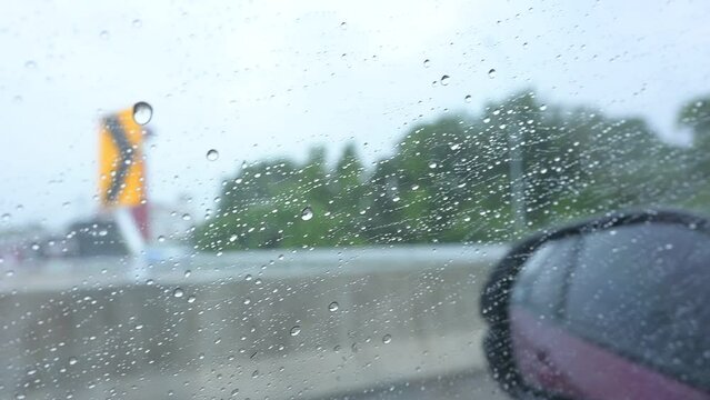 side mirror of car driving in rainny day