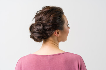 beautiful female hairstyle rear view. The woman's hair is arranged in a bun