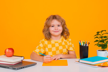 Nerd pupil boy from elementary school with book isolated on yellow studio background. Smart genius...