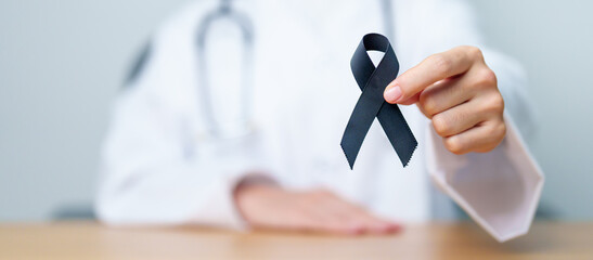 Melanoma and skin cancer, Vaccine injury awareness month and rest in peace concepts. doctor holding...