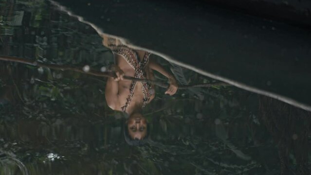 Reflection of a Man paddling in a Canoe in Amazon