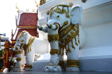 Carving sculpture antique holy elephants statue on ancient chedi pagoda stupa for thai people travelers travel visit respect praying blessing mystery at Wat Ming Mueang temple in Chiang Rai, Thailand