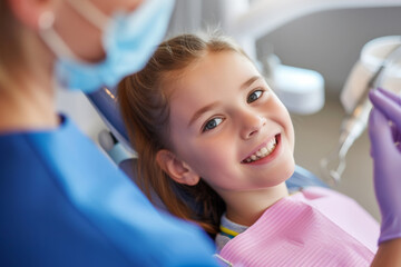 Radiant smile of a young patient in dental chair, creating a comforting atmosphere in pediatric dentist's clinic
