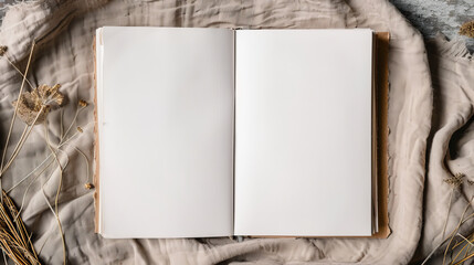 An aesthetically pleasing open book lies on soft fabric, blank label visible, complemented by natural elements and muted tones
