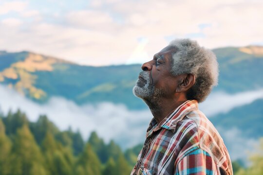 African man enjoying the fresh morning air on the mountain, calming refreshing