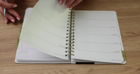 Woman opens diary and begins to write down her daily routine
