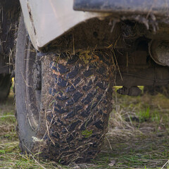 Dirty wheels of off-road car on natural background