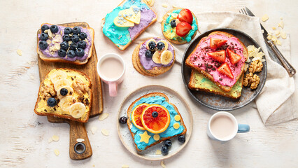 Sweet breakfast with cup of cocoa. Toast with cream cheese, banana, strawberries, blueberries